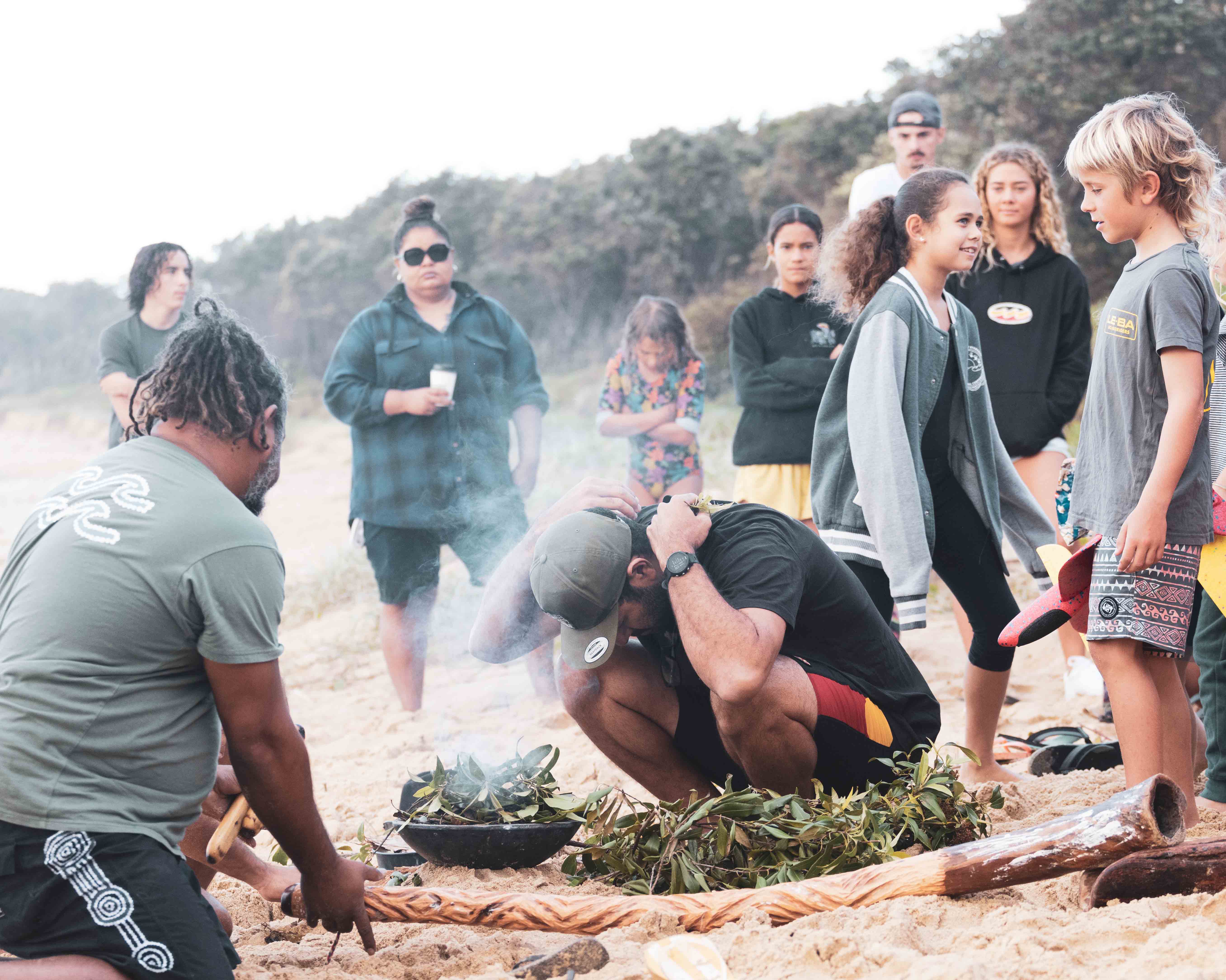 people around a fire at a land connection ceremony 