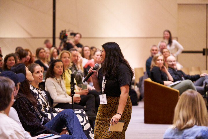 an audience member at global summit 2023 asking a question on the microphone